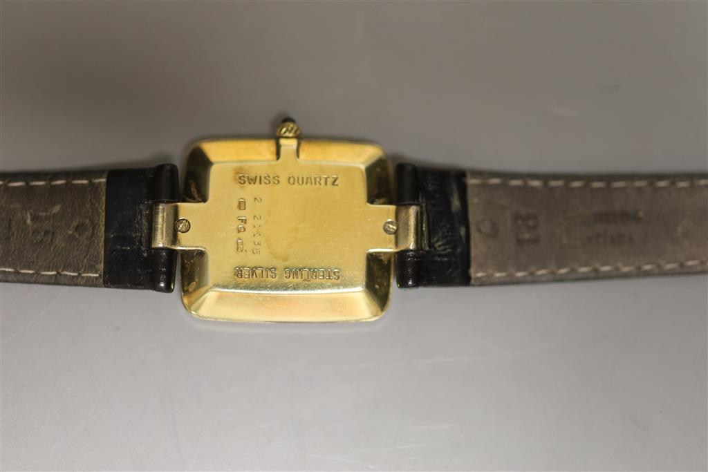 A gentlemans silver gilt Dunhill quartz shaped rectangular dial wrist watch, on a leather strap with Dunhill clasp,